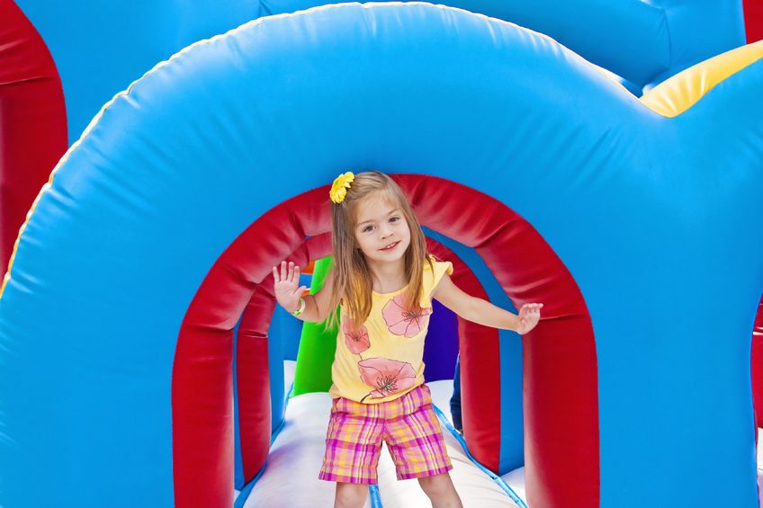 Girl playing on an inflatable ride at her school carnival!