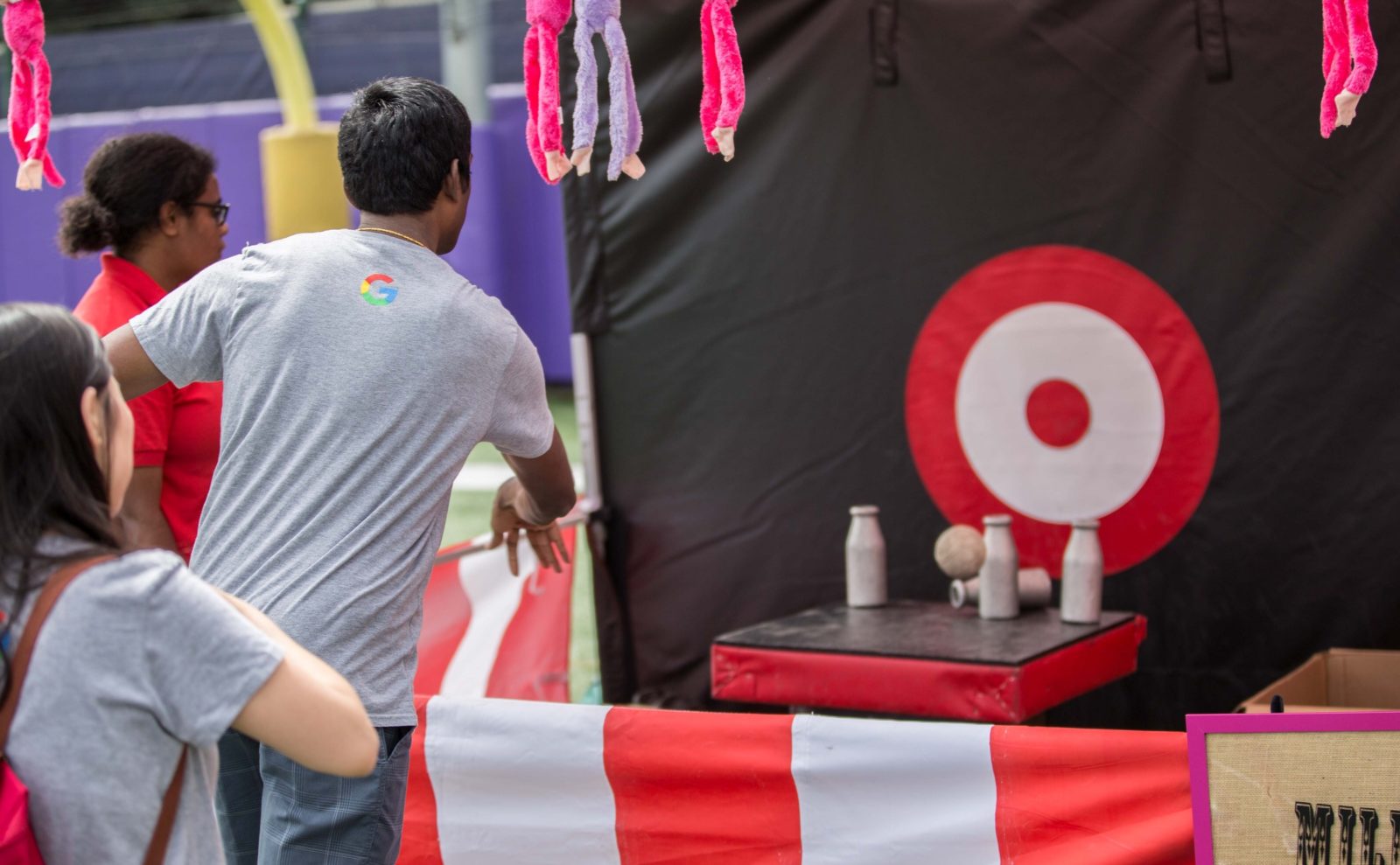 classic bottle smash carnival game at a company picnic