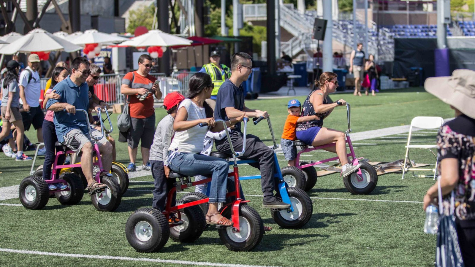 giant tricycle race at a company picnic