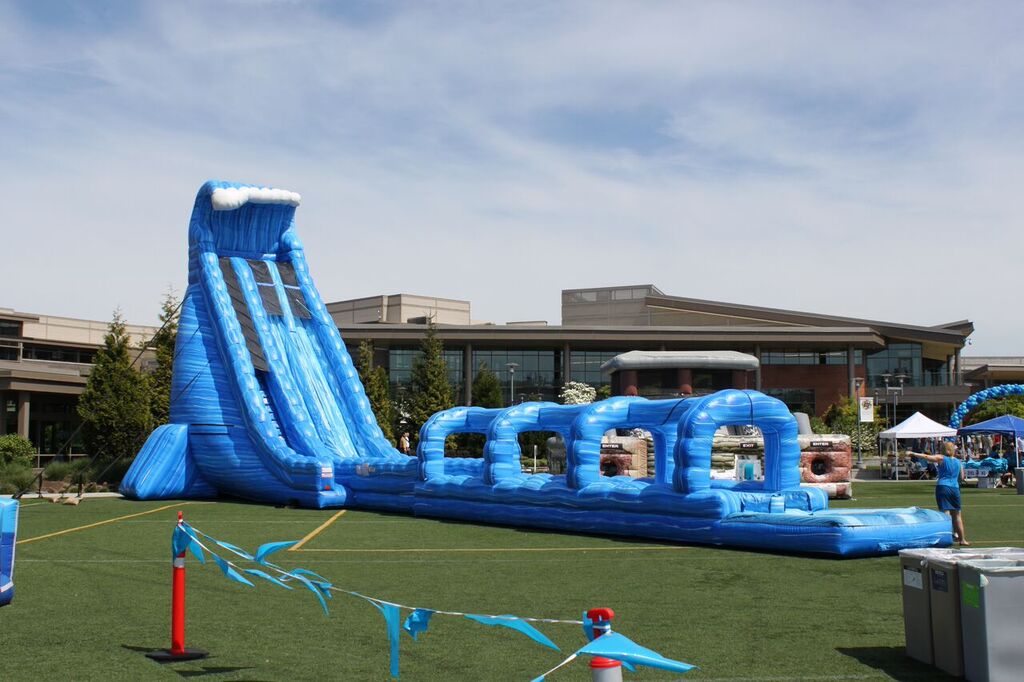 100′ Long Blue Crush Xtreme Water Slide rental at a summer company picnic