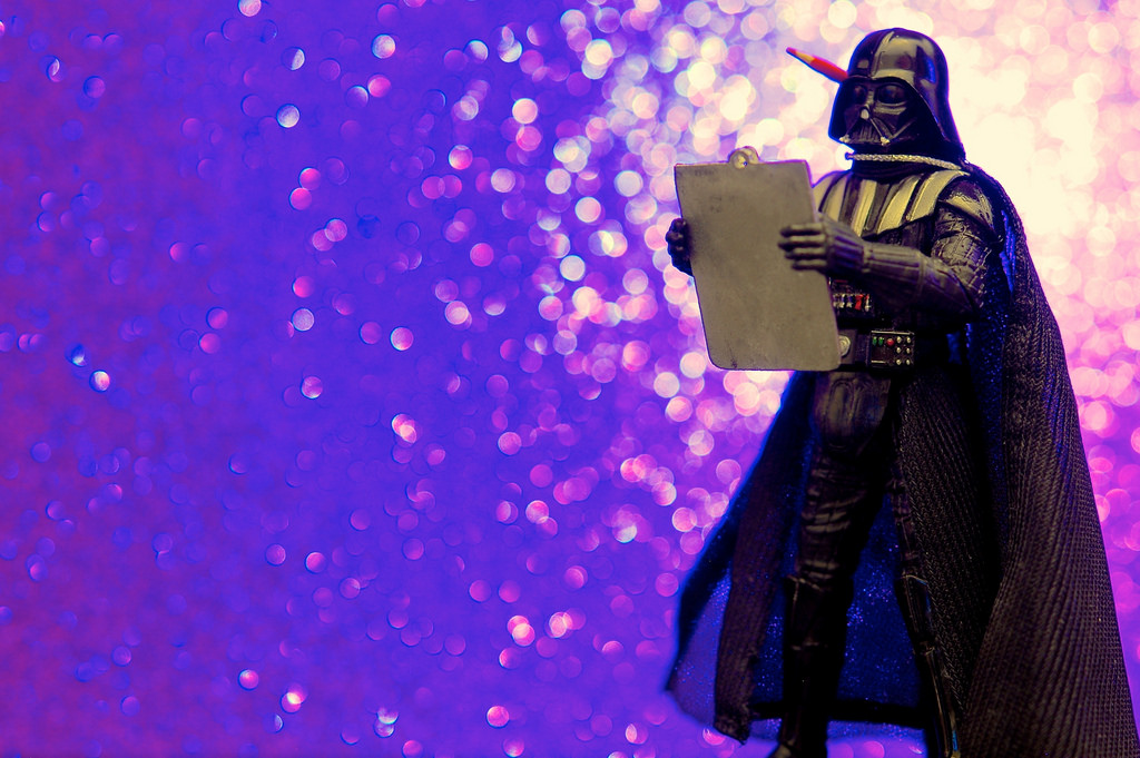 Darth Vader holding a clipboard and pencil