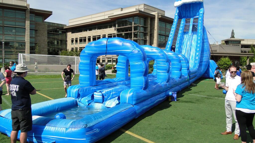 100′ Long Blue Crush Xtreme Water Slide rental at a summer company party
