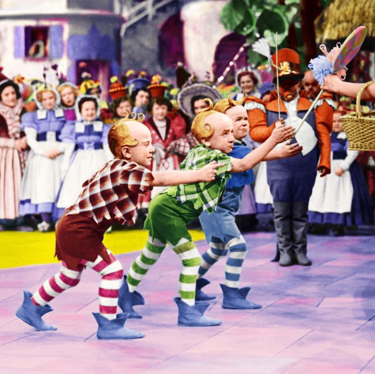 Munchkins presenting a lollipop in The Wizard of Oz