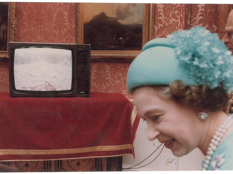 Queen Elizabeth II watching the wedding of Princess Diana and Prince Charles on TV