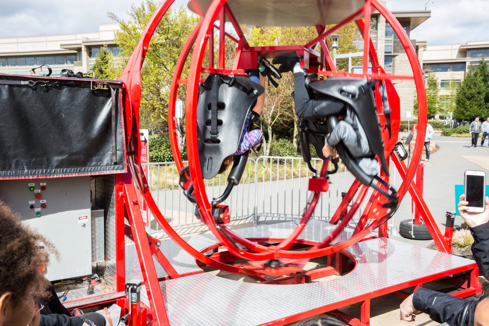 human gyroscope ride at a company picnic