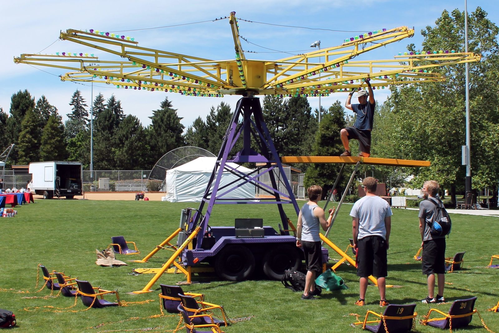 event production company setting up a carnival ride at a community event