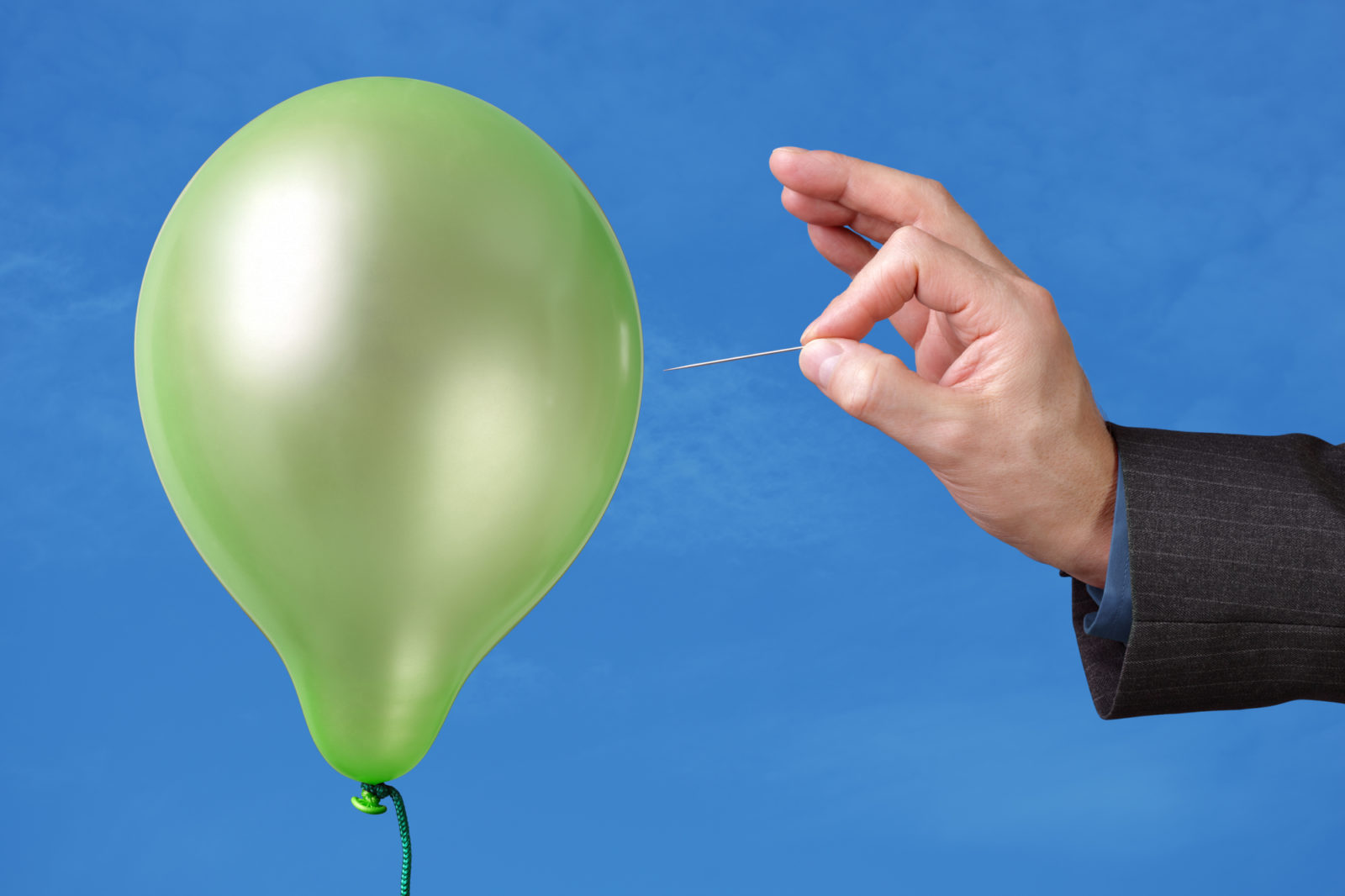 man popping balloon 