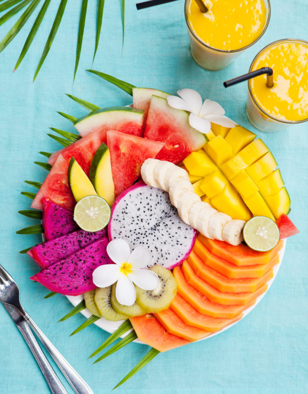 Tropical fruits assortment with mango smoothie