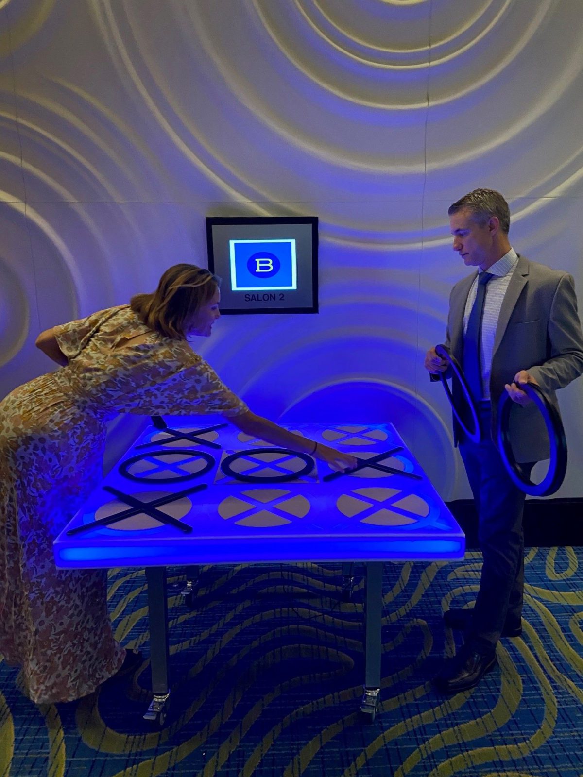 People playing LED Tic Tac Toe at an event
