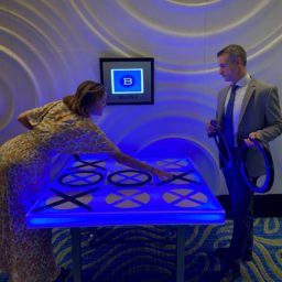 People playing LED Tic Tac Toe at an event